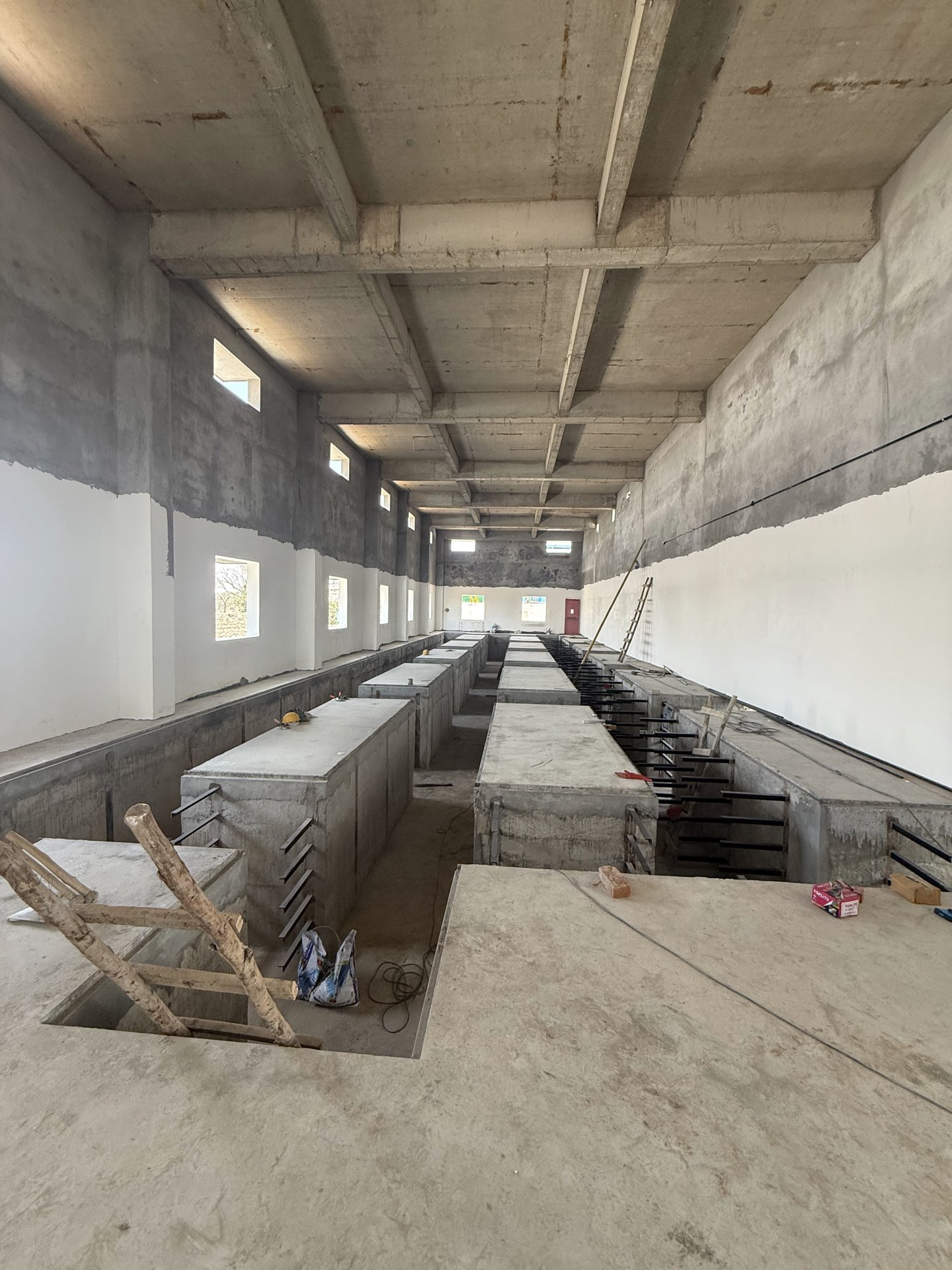 Industrial interior with machine foundations under construction